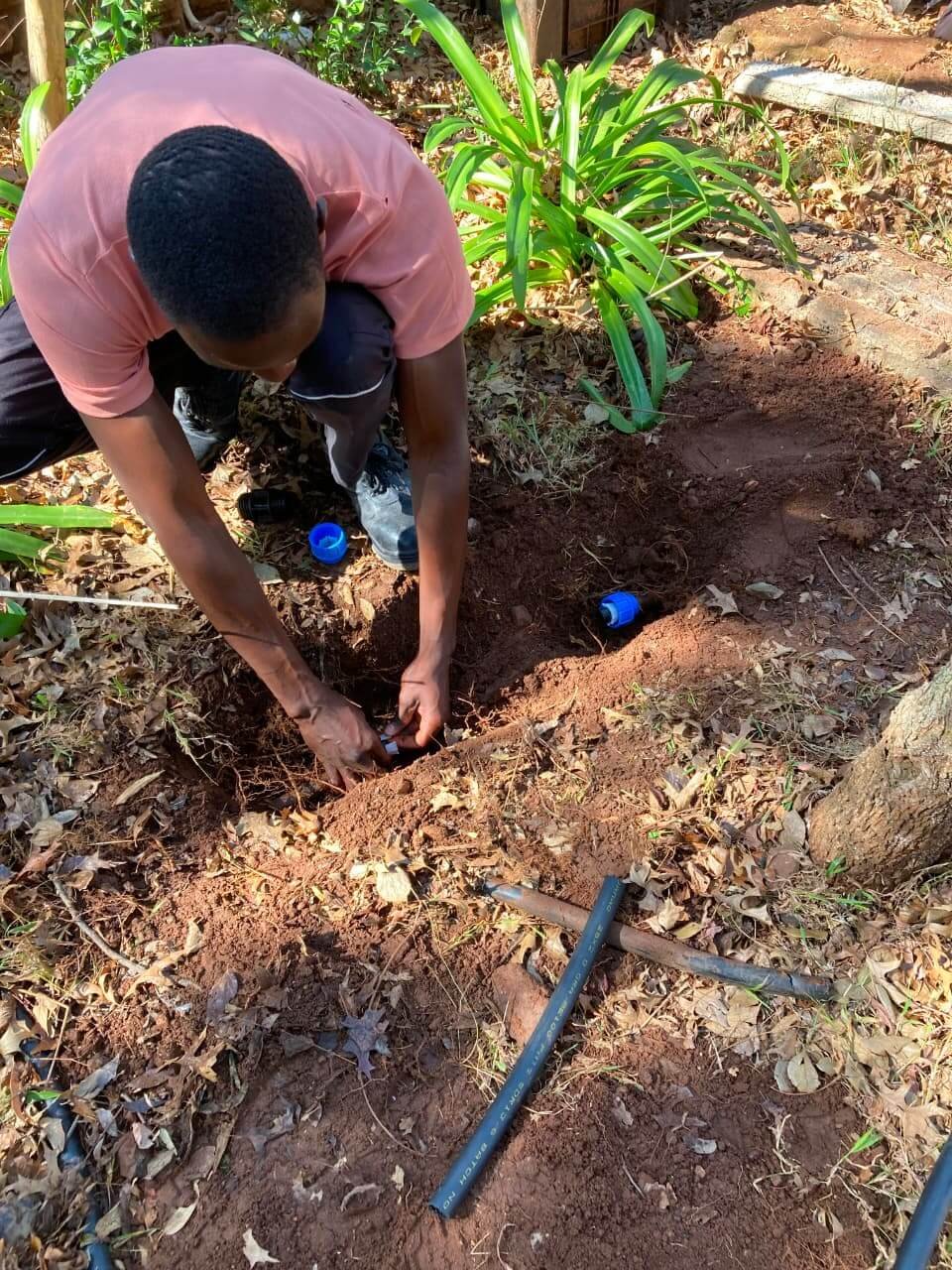 Sandton Plumber working on a drain